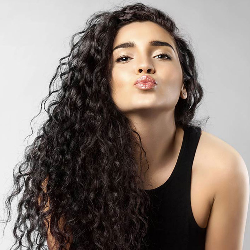 Model wearing long curly hair extensions
